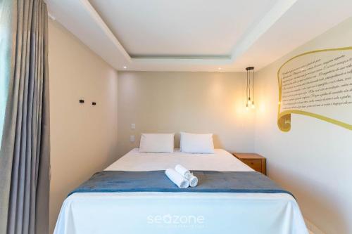 a bedroom with a bed with a towel on it at Apto c/ Vista Mar a 200m da Praia TSR0501 in Cururupe