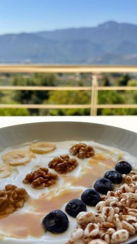 a plate of milk with blueberries and nuts on it at Marlou Health&Fit Club in Buccino