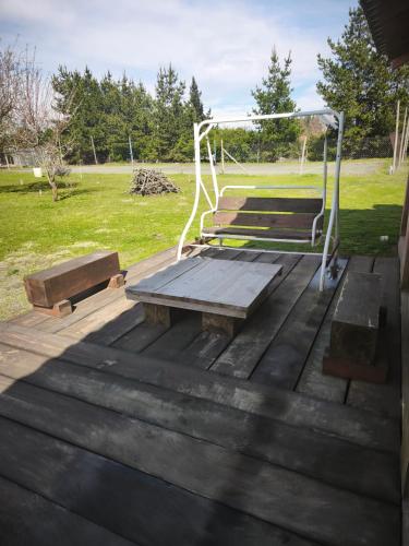 a picnic table and benches on a deck at Departamento tipo estudio en Condominio Plaza San Marcos in Los Ángeles