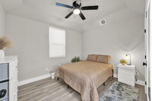 a bedroom with a bed and a ceiling fan at Spacious 3BR Home w Yard Smart TV Parking in Humble
