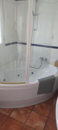 a white bath tub with a shower in a bathroom at Casa Del Sol La Herradura in La Herradura