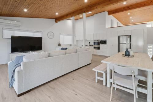 a living room with a large couch and a table at Serenity by the Lake in Rocky Point