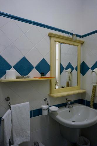 a bathroom with a sink and a mirror at Hotel Stella 2000 in Olbia