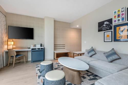 a living room with a couch and a table at Cambria Hotel Austin Downtown in Austin