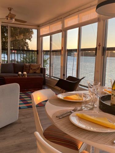 a dining room with a table with a view of the water at The Verne: Beautiful Waterfront Escape by Picton in Picton