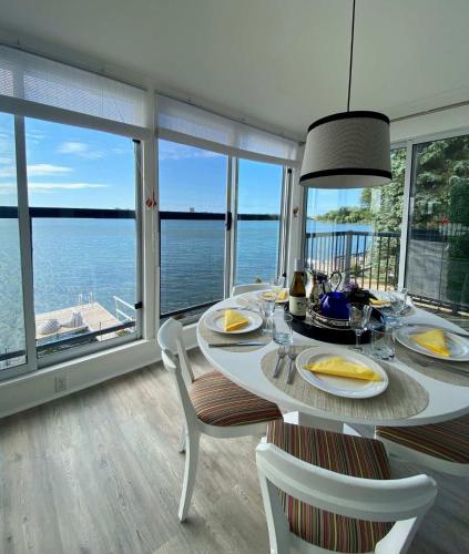 a dining room with a table and views of the ocean at The Verne: Beautiful Waterfront Escape by Picton in Picton