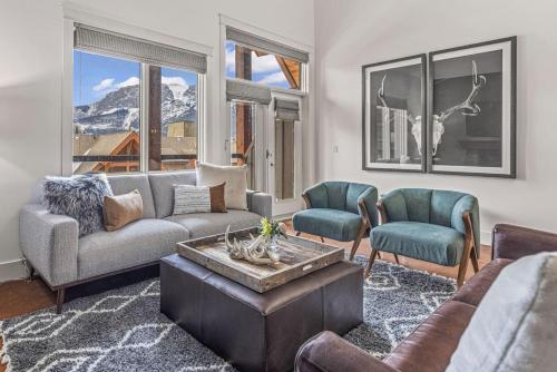a living room with a couch and chairs and a table at Amazing mountain Views 3BR Penthouse with private Balconies in Canmore