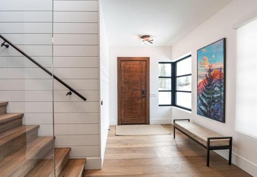 a hallway with stairs and a painting on the wall at Sitka Spruce Mountain Chalet in Revelstoke