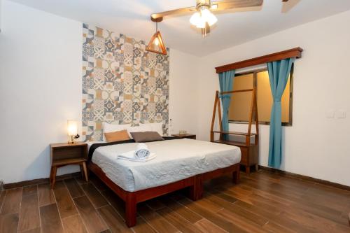 a bedroom with a bed and a table and a window at Suucilha in Valladolid
