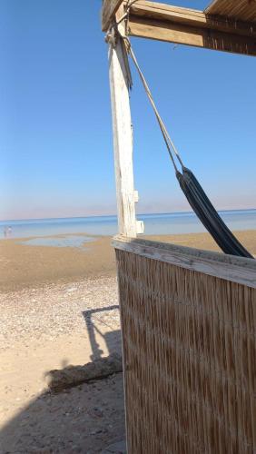 a building on a beach with the ocean in the background at Soul camp in Nuweiba‘ el Muzeinah