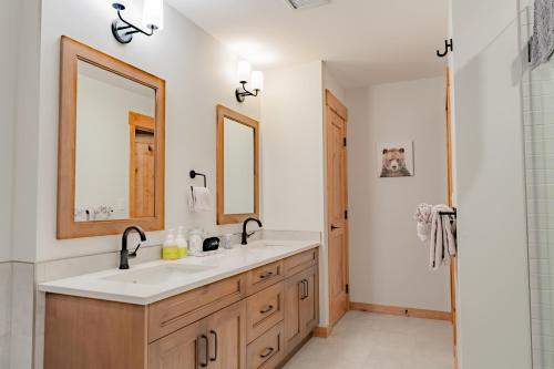 a bathroom with a sink and a mirror at Timberstone Condo by Canadian Rockies Vacation Rentals in Canmore