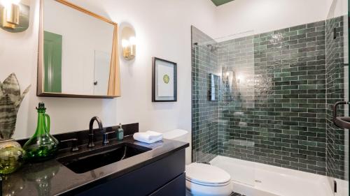 a bathroom with a sink and a toilet and a shower at Pickle Factory - In A Pickle Retro Loft 2 bedroom in Covington