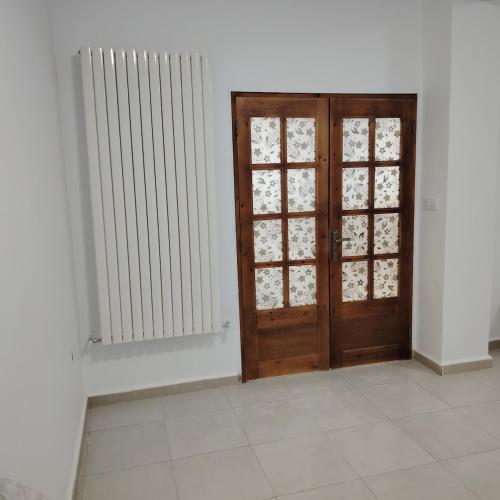 a room with a wooden door and a radiator at New spacious equipped 3room apartment with garage in Skikda