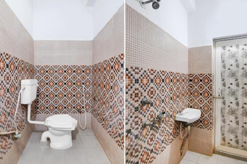 a bathroom with a toilet and a shower at Hotel O The Lord Jagannath Guest House in Puri