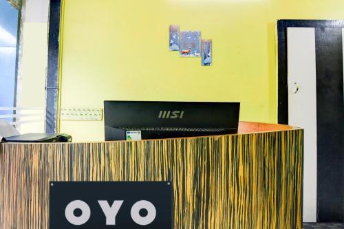 an office counter with a laptop on top of it at Hotel O The Lord Jagannath Guest House in Puri