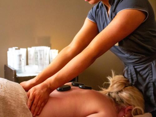 a womanolithing a pregnant woman on a bed at Ravenport Resort in Wexford