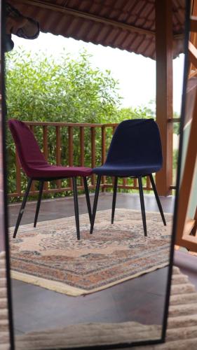 a pair of chairs sitting on a porch at The Green Arc in Gurgaon