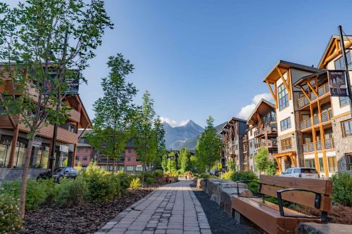 a street in a town with buildings and benches at Timberstone Condo by Canadian Rockies Vacation Rentals in Canmore