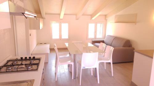 a kitchen and dining room with a table and chairs at Il Cuore del Borgo - Holiday Home in Borgomaro