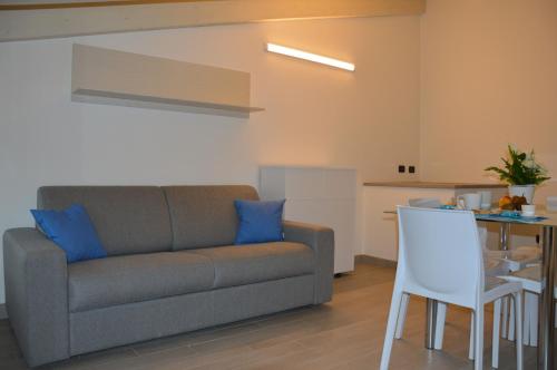 a living room with a couch and a table at Il Cuore del Borgo - Holiday Home in Borgomaro