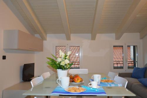 a living room with a table with food on it at Il Cuore del Borgo - Holiday Home in Borgomaro