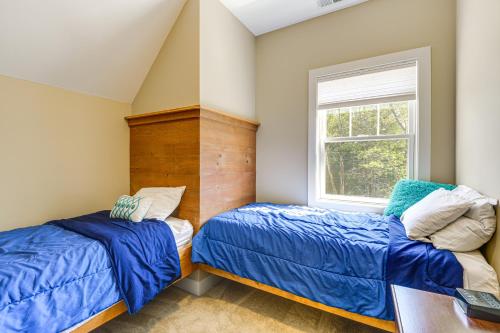two beds in a room with a desk and a window at 2 Mi to Golfing and Hiking Spacious Wilmington Home in Wilmington