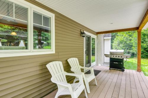 two white chairs on a porch with a grill at 2 Mi to Golfing and Hiking Spacious Wilmington Home in Wilmington