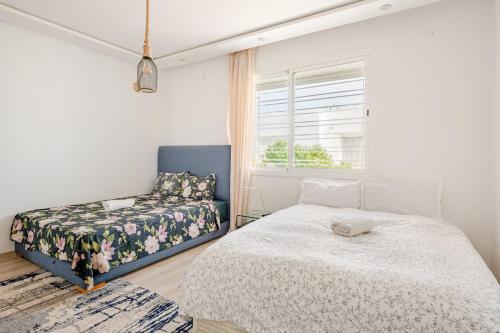 a bedroom with a bed and a window at La Villa des Rochers in Temara