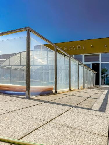 a building with a glass walkway in front of it at Apartmán s krásným výhledem na jezera a Pálavu in Pasohlávky