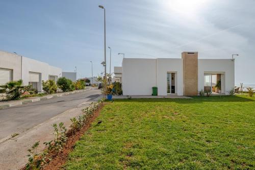 a white building on the side of a street at La Villa des Rochers in Temara