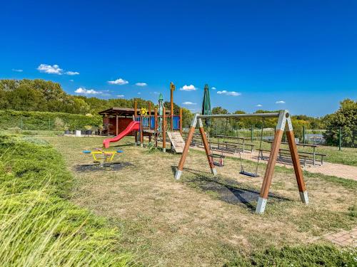 a park with a playground with a slide at Apartmán s krásným výhledem na jezera a Pálavu in Pasohlávky