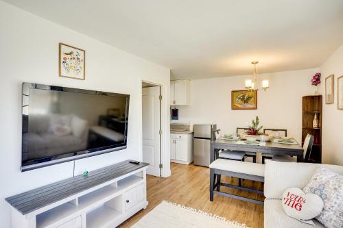 a living room with a large flat screen tv on a wall at Explore SoCal! Cozy Retreat Near Disney and Beaches in Westminster