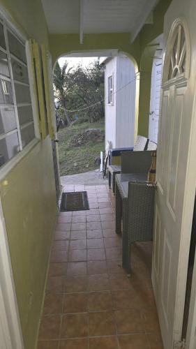 an entrance to a house with chairs and a porch at Tropical Retreat in Matthews