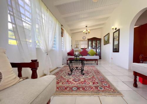 a living room with a couch and a table at Tropical Retreat in Matthews