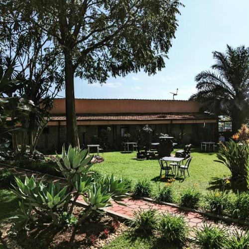 a building with a table and chairs in a yard at Inside Afrika Boutique Hotel in Kigali
