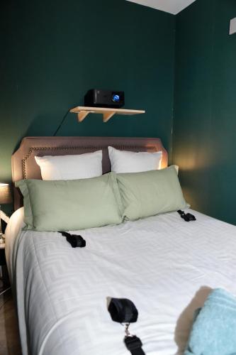 a bed with two black shoes on top of it at LoveRoom La Petite Suite avec SPA in Brest