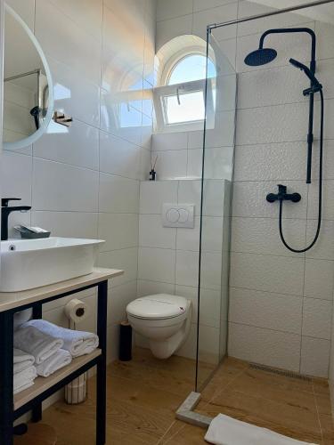 a bathroom with a shower and a toilet and a sink at Motel Marić in Žepče