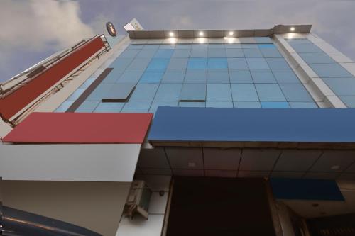 a tall building with red white and blue at Collection O Greenpark in Jamshedpur