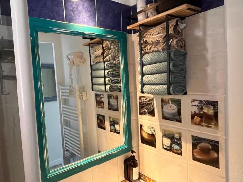 a mirror on a wall next to a bathroom at Blue Lagoon in Six-Fours-les-Plages