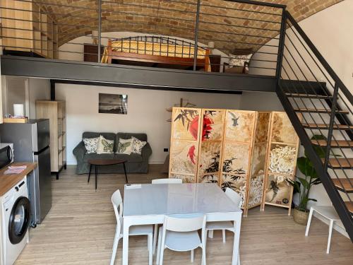 a living room with a table and a loft at La casina di Soccorsa in Poggio Imperiale