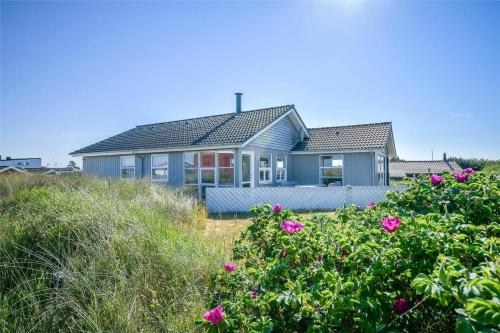 a blue house on the beach with pink flowers at 0073-Romo-Lakolk-172 in Lakolk