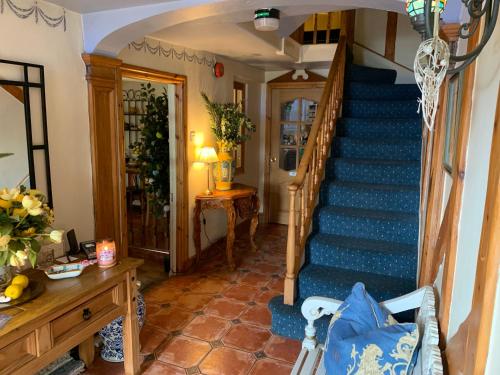 a hallway with a blue staircase in a home at The Suites At Ty Anne in Beaumaris
