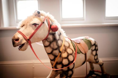a toy horse is dressed up as a dog at The Queen's Head in Kingston upon Thames