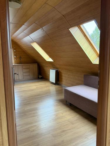 a attic room with a bed and a skylight at SkyChatka Zwardon in Zwardoń