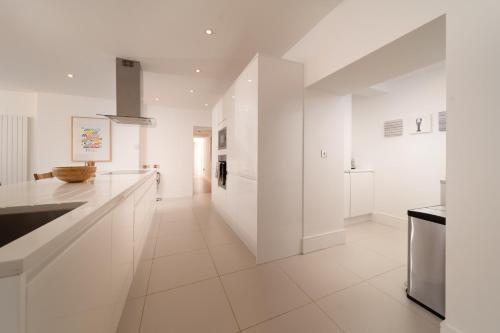 a kitchen with white walls and white appliances at Tors Park in Lynmouth