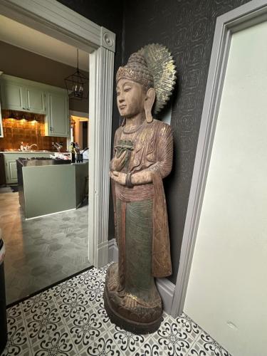 a statue of a man with his arms crossed on a wall at Charming Unique Themed Victorian Elegance in Eureka