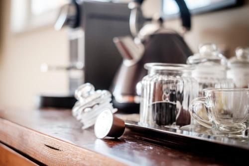 a counter with several glass jars and a tea kettle at The Queen's Head in Kingston upon Thames