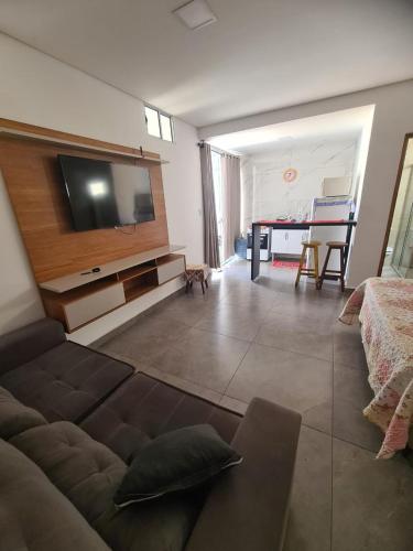 a living room with a couch and a flat screen tv at MP flat CDA in Araxá