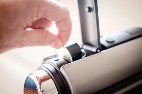 a person is holding the knob of a camera at The Queen's Head in Kingston upon Thames