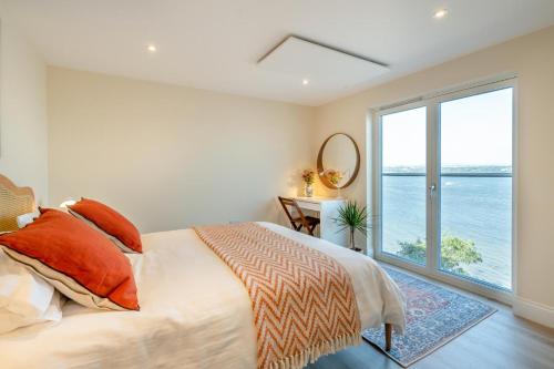 a bedroom with a bed and a large window at Wash House - Tayport in Dundee